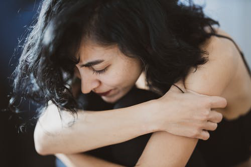 Photo of a woman experiencing anxiety, worry, and emotional distress.