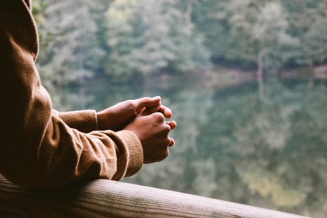 A person leaning against a railing before getting alcohol addiction help in Barrow County