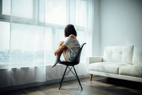 A woman sitting in a chair before getting anxiety counseling in Barrow County