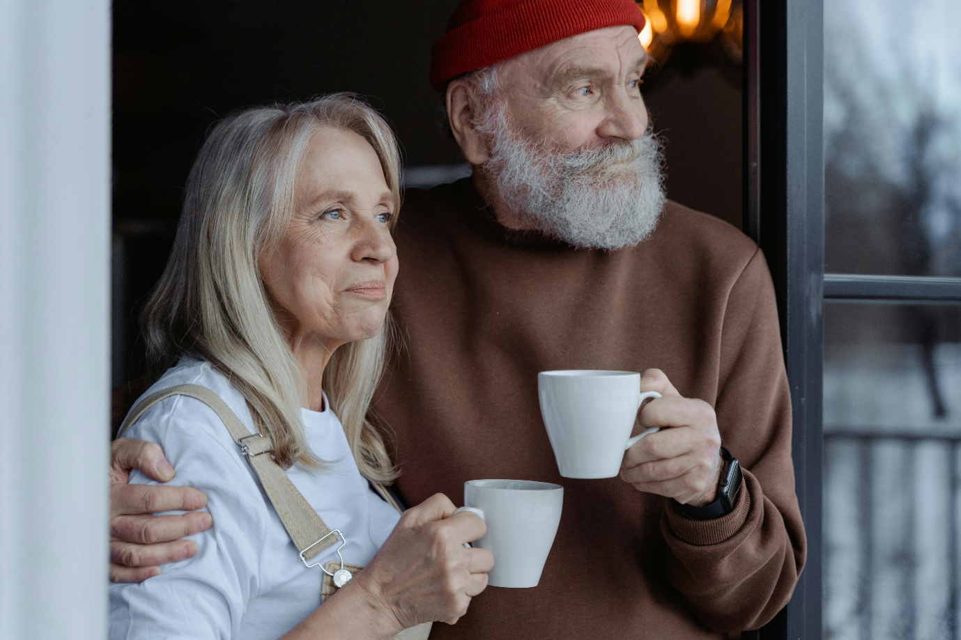 an old couple holding mugs